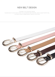 Detail of five multi-colored leather belts with vintage gold-tone oval metal buckles