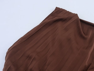 Detail view of the elegant brown pleated fabric texture with a smooth satin finish