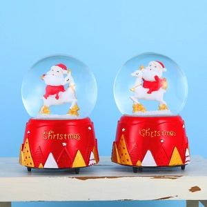 Rotating Christmas snow globe music box with Santa riding a reindeer on red base
