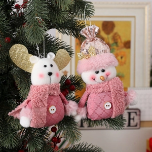Pink plush Christmas ornaments featuring snowman and reindeer on a green tree branch