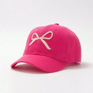 Detail of the 3D embroidered bow on this vibrant pink twill cotton baseball cap