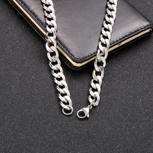 Close-up of thick silver Cuban chain link necklace with a secure lobster clasp closure