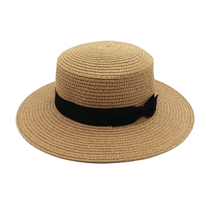 Classic straw boater hat in natural beige with black ribbon and bow for summer beach sun protection