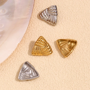 Detail of 18K gold and silver plated triangle earrings with unique ribbed texture