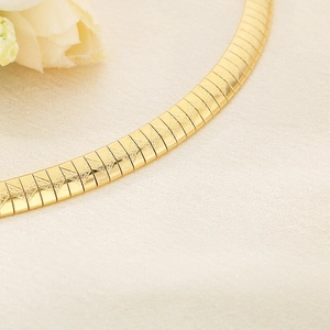 Macro detail of golden stainless steel flat chain with fine geometric textured surface