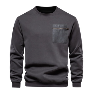 Detail of grey crewneck sweatshirt featuring a functional metal zipper chest pocket