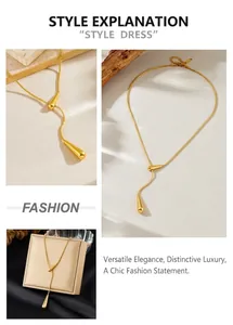 Detail of a gold-plated teardrop pendant on a sleek snake chain in Y-shape style