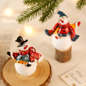 Miniatur-Schneemann-Figurenset auf Holzsockel mit festlichen Tannenzweigen und Lichtern