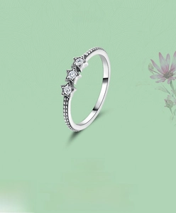 Detail of silver star ring featuring beaded band and three cubic zirconia stars