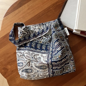 Close-up of bohemian paisley linen shoulder bag with magnetic snap and brand label