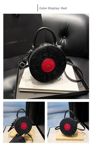 Detail of vintage record shaped crossbody bag featuring cartoon embossed texture and red center