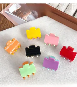 Macro shot of colorful mini macaron acrylic hair claws in assorted bright glossy finishes