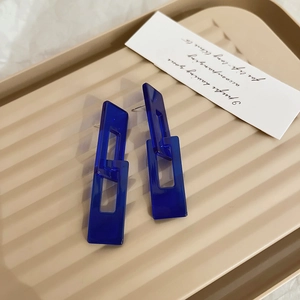 Detail of Klein blue acrylic earrings showing the translucent double rectangle link design