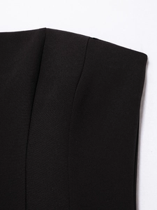 Macro shot of high-quality black woven fabric texture on a short off-shoulder dress