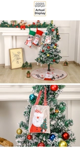 Detail of burlap Christmas gift bag with Santa Claus cartoon and festive handle