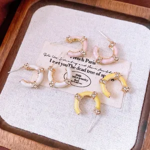 French vintage bamboo-style C-shaped hoop earrings with gold trim and sparkly diamonds