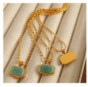 Macro shot of rectangular green amazonite pendant on gold stainless steel bead chain