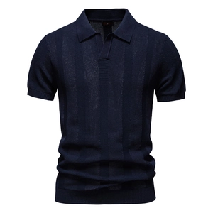 Detailed macro view of the dark blue knitted polo shirt with vertical stripe texture