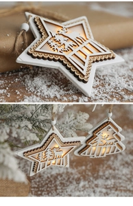 Detail of wooden star and tree ornaments with warm LED lights and reindeer carvings