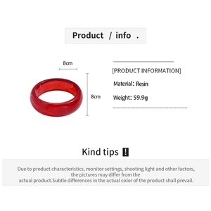Detail view of 8x8cm red resin bangle showing weight and smooth geometric texture