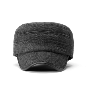 Detail view of winter baseball cap showing herringbone fabric and black leather trim