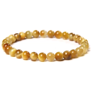 Macro detail of natural tiger eye stone beads with polished texture and cat-eye effect