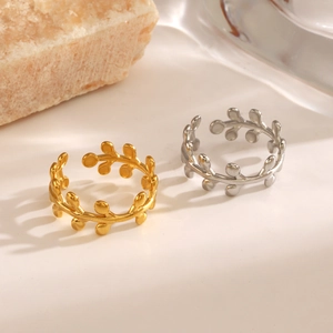 Leaf design open rings in gold and silver finish with natural stone background