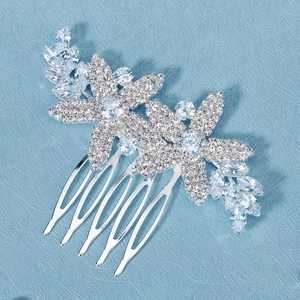 Macro detail of bridal hair comb with cubic zirconia flower petals and silver leaves
