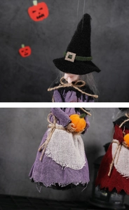 Detailed close-up of handmade Halloween witch hanging dolls in purple and red linen outfits