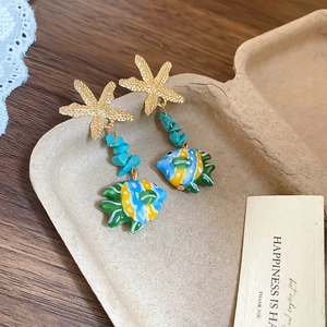 Detail of starfish earring with turquoise beads and colorful tropical fish pendant