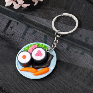 Realistic sushi platter keychain with miniature salmon and rolls on dark textured background