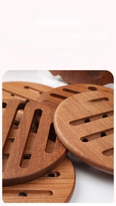 Close-up of stacked round ebony wood heat insulation pads with striped cutout design