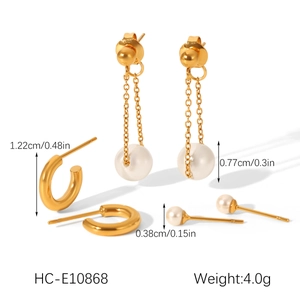 Detailed view of gold stainless steel earring set with pearls and zircons on white background