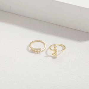 Detailed close-up of 14K gold plated Love letter ring with white pearls and zircons