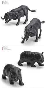 Detailed view of realistic miniature buffalo and black bear animal figures with textured fur