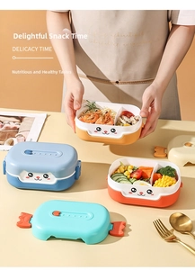 Detail of multi-compartment cartoon cat bento box with pasta, shrimp and fresh vegetables