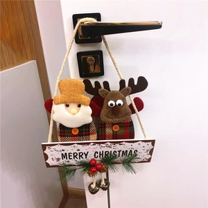 Festive Christmas door hanger with Santa, reindeer, bells and pine cones on a Merry Christmas sign