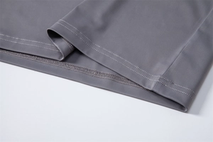Detailed close-up of double-stitched hem on grey UPF100+ sun protection shirt