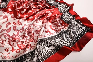 Close-up of red and white paisley silk scarf showing soft texture and detailed pattern