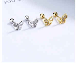 Detail of 925 sterling silver butterfly stud earrings with sparkling cubic zirconia stones