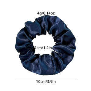 Detailed view of dark blue satin scrunchie showing 10cm outer and 4cm inner diameter