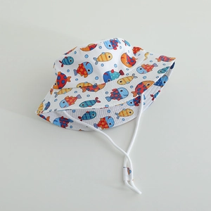 Detailed view of kids bucket hat with colorful fish prints and white chin strap