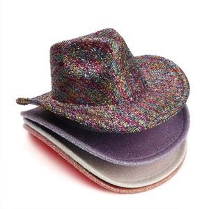 Close-up of sparkling sequin cowboy hats in vibrant neon, silver, and purple shades