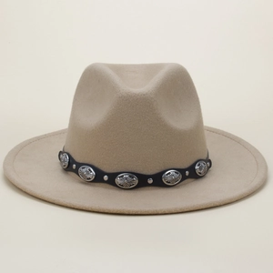 Detail of tan fedora hat featuring black band with silver floral buckles and rivets