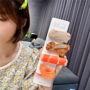 Macro detail of realistic 5-piece food hair clip set with meat and vegetable designs