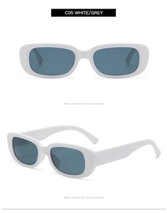 Detail view of white vintage cat eye sunglasses with grey lenses and retro oval frame