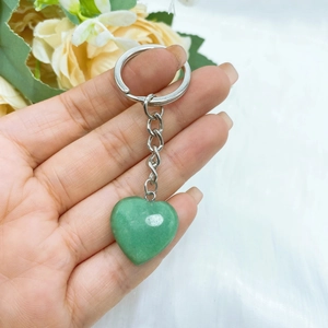 Close-up of heart-shaped green aventurine stone keychain with polished silver metal ring