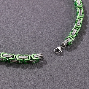Macro shot of 8mm stainless steel Byzantine chain with green and silver two-tone links