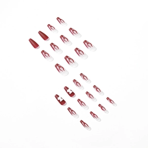 Long coffin fake nails featuring burgundy flame art and 3D bow accents on white base