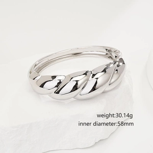 Detailed view of silver twisted textured open bangle on white stone with specifications